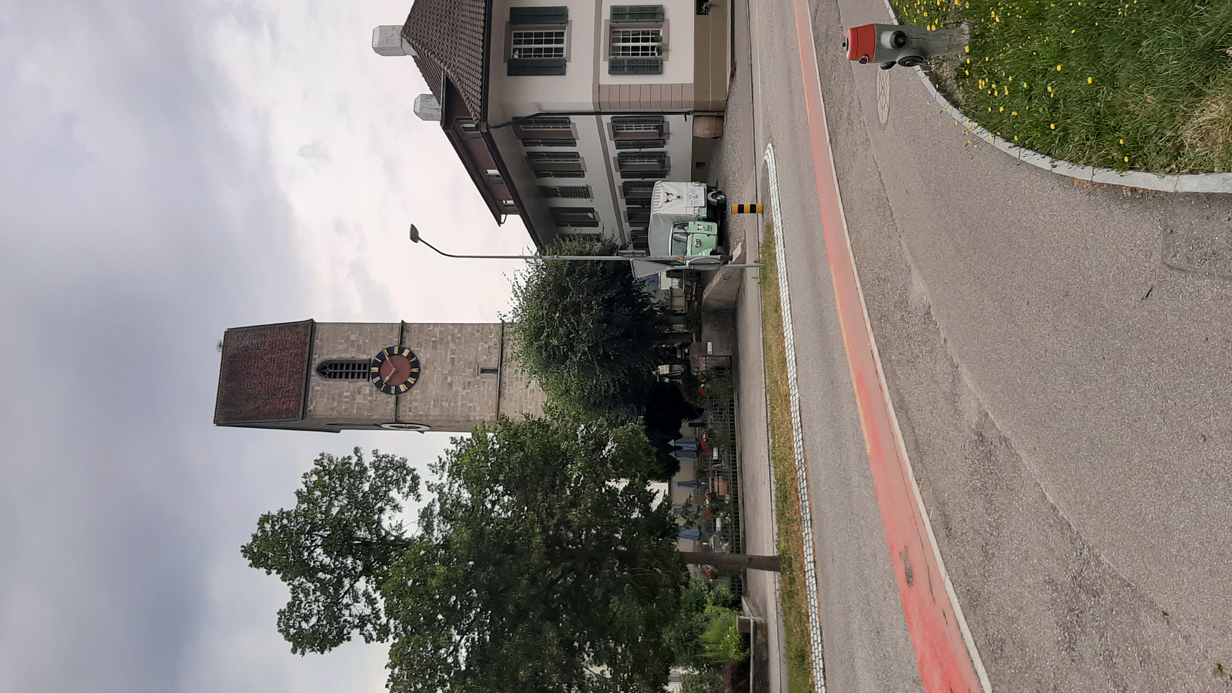 Medieval clock tower beside the road in a Swiss town