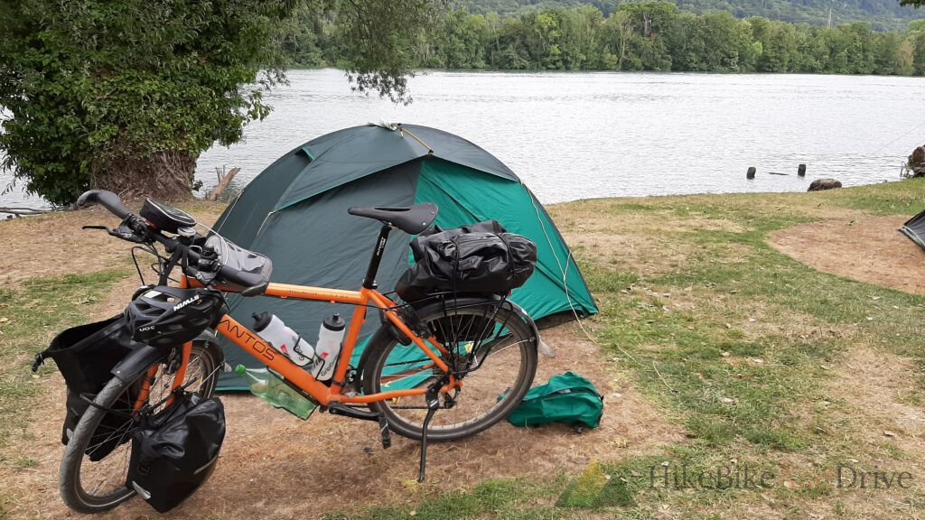 Touring bike and tent at the campsite on the Rhine