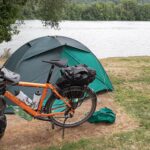 Touring bike and tent at the campsite on the Rhine