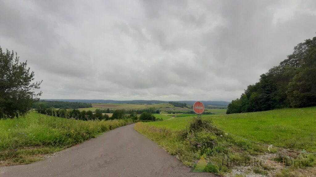 Quiet country road through rolling hills in Haute-Saône