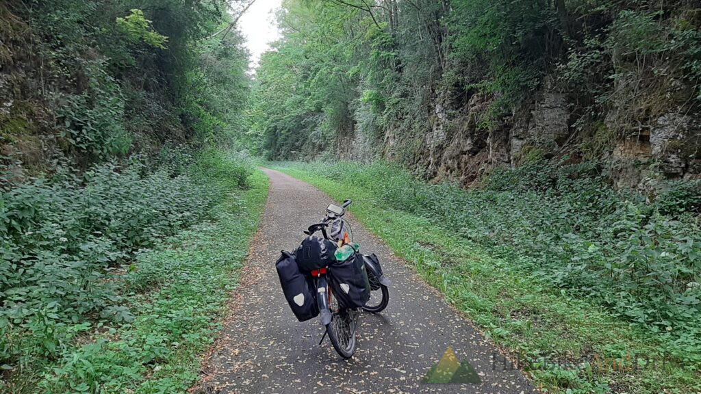 Loaded touring bike on a former railway path through the woods